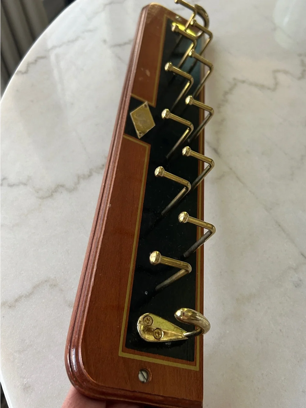 Vintage Wall-Mounted Tie Rack with Gold Hooks and Black Accent